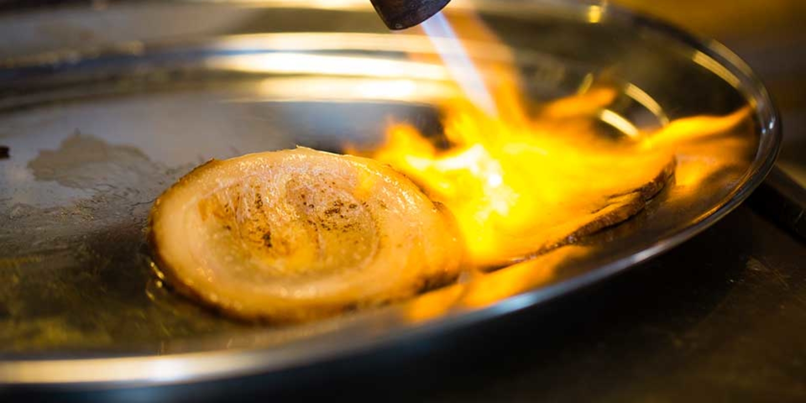 Kitchen image of RAKKAN RAMEN, Burning Grilled Pork with a burner